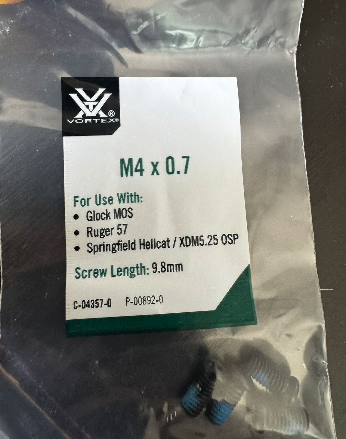 The Vortex Defender-CCW mounting hardware, showing several packets of screws in different sizes supplied with the optic.